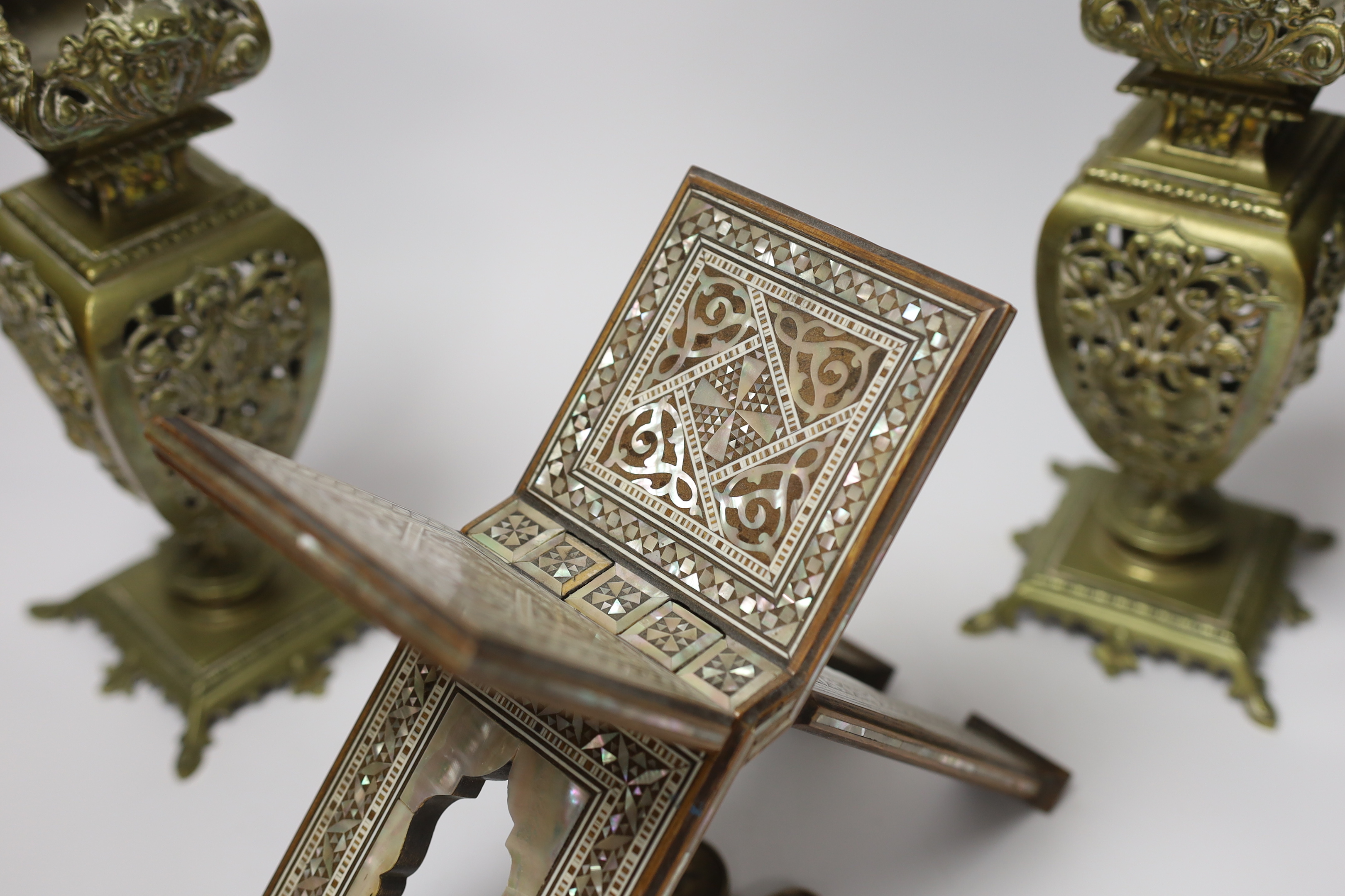 A pair of early 20th century brass garnitures, a German brass tachometer and a mother of pearl inlaid Quran stand, tallest 25cm